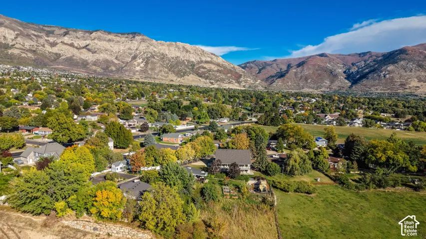 Expansive mountain range backdrop and verdant tree-lined surroundings
