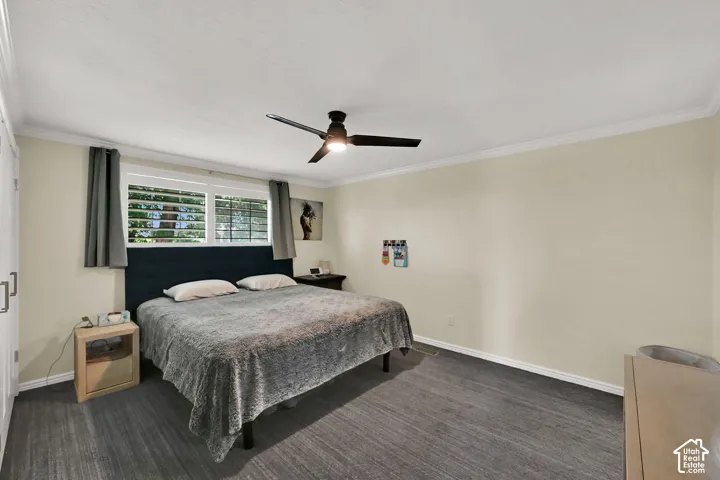 Neutral tone walls, crown molding, and wood-finish flooring