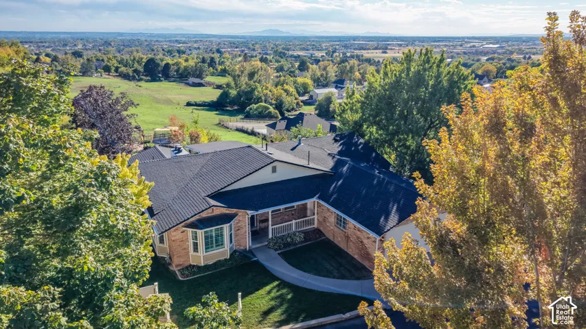 Brick and siding exterior with a dark shingle roof