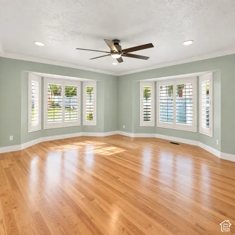 Polished wood-finish flooring, recessed lighting, and a ceiling fan with integrated lighting