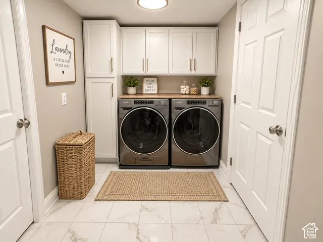 White shaker-style cabinetry with gold-tone hardware, wood-finish countertop, and large format white tile flooring with veining
