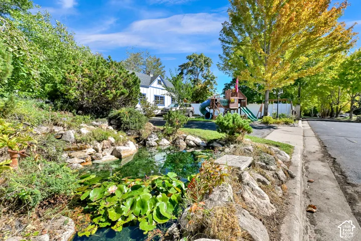 Lush landscaping with a rock-lined pond and water features