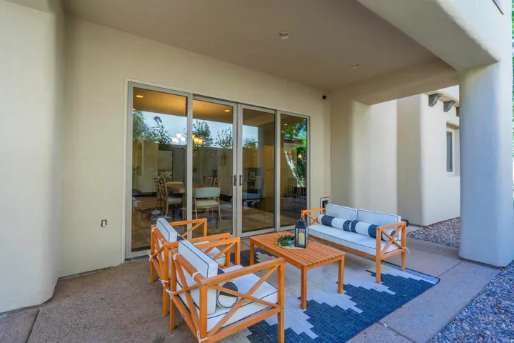 Covered patio with a concrete surface, stucco walls, and sliding glass doors