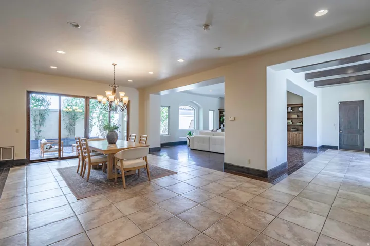 Tiled flooring throughout, recessed lighting, and a multi-light chandelier