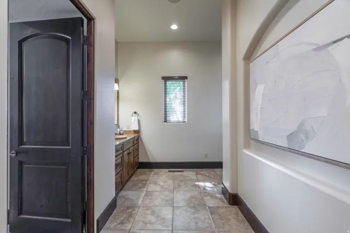 Tile flooring with dark wood baseboard trim