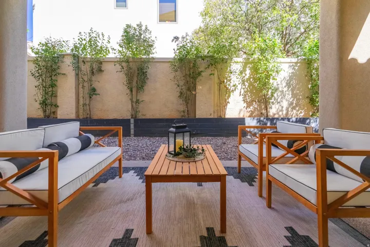 Covered patio with textured wall, and lush plantings