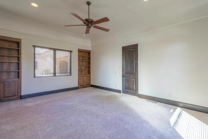 Ceiling fan with wooden blades, recessed lighting, and a window with blinds