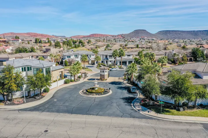 Gated community entry with a circular drive and central tiered fountain
