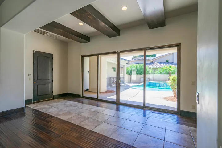 Hardwood-finish flooring with tile inlay