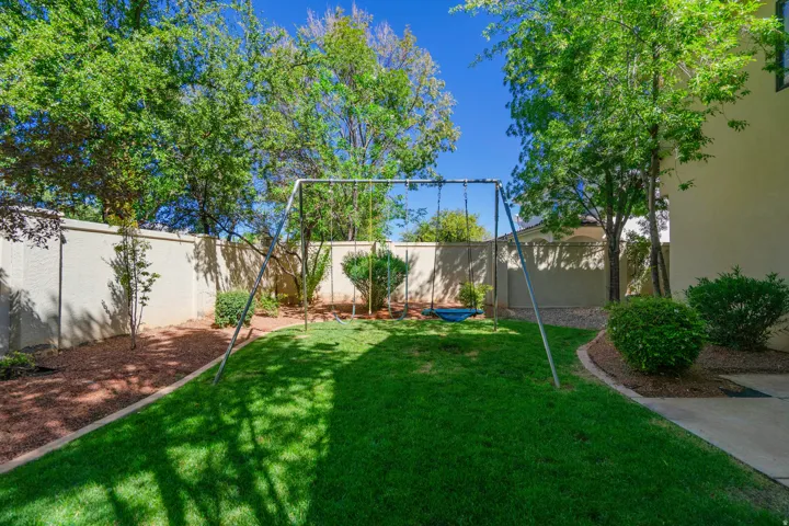 Expansive private backyard with a vibrant lawn, mature trees, and landscaping