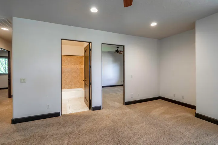 Recessed lighting, wood-finish doors, carpeted flooring, and dark wood-finish trim