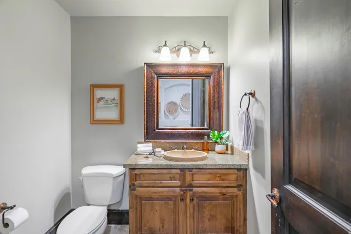 Wood vanity with a natural stone countertop and integral sink