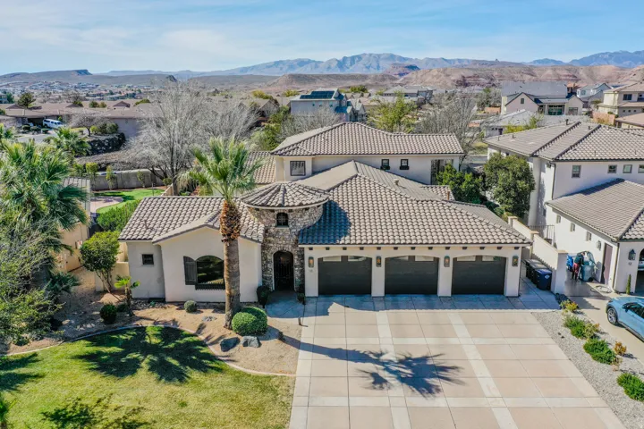 Stucco exterior with stone accents and a tile roof