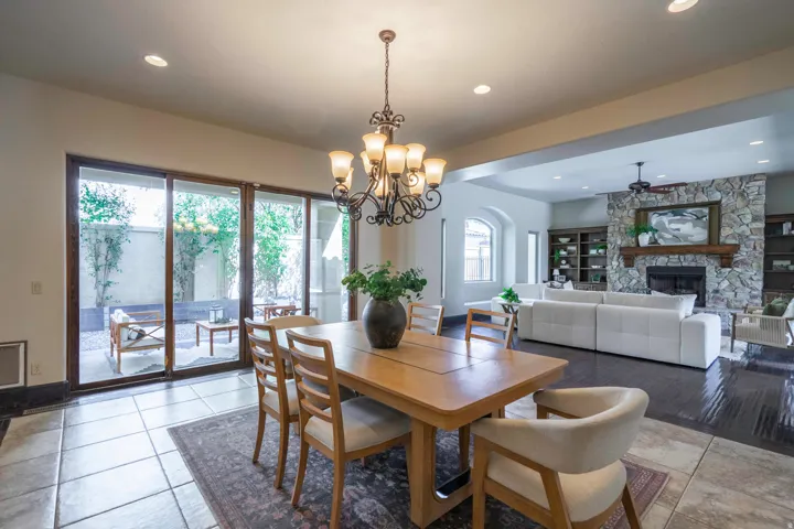 Dining area with a chandelier, tile flooring, and sliding glass doors opening to an outdoor patio
