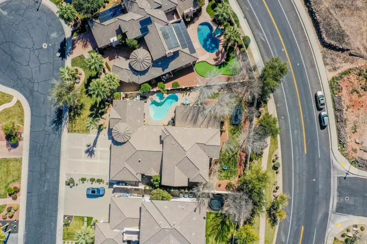 Property with a tile roof, an exterior swimming pool.