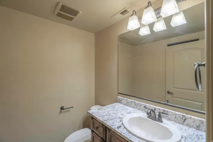 Vanity with an integrated sink and light-toned countertop