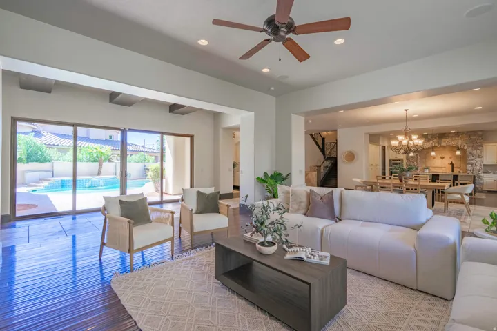 Open-concept living area featuring wood-finish flooring, a ceiling fan, and recessed lighting