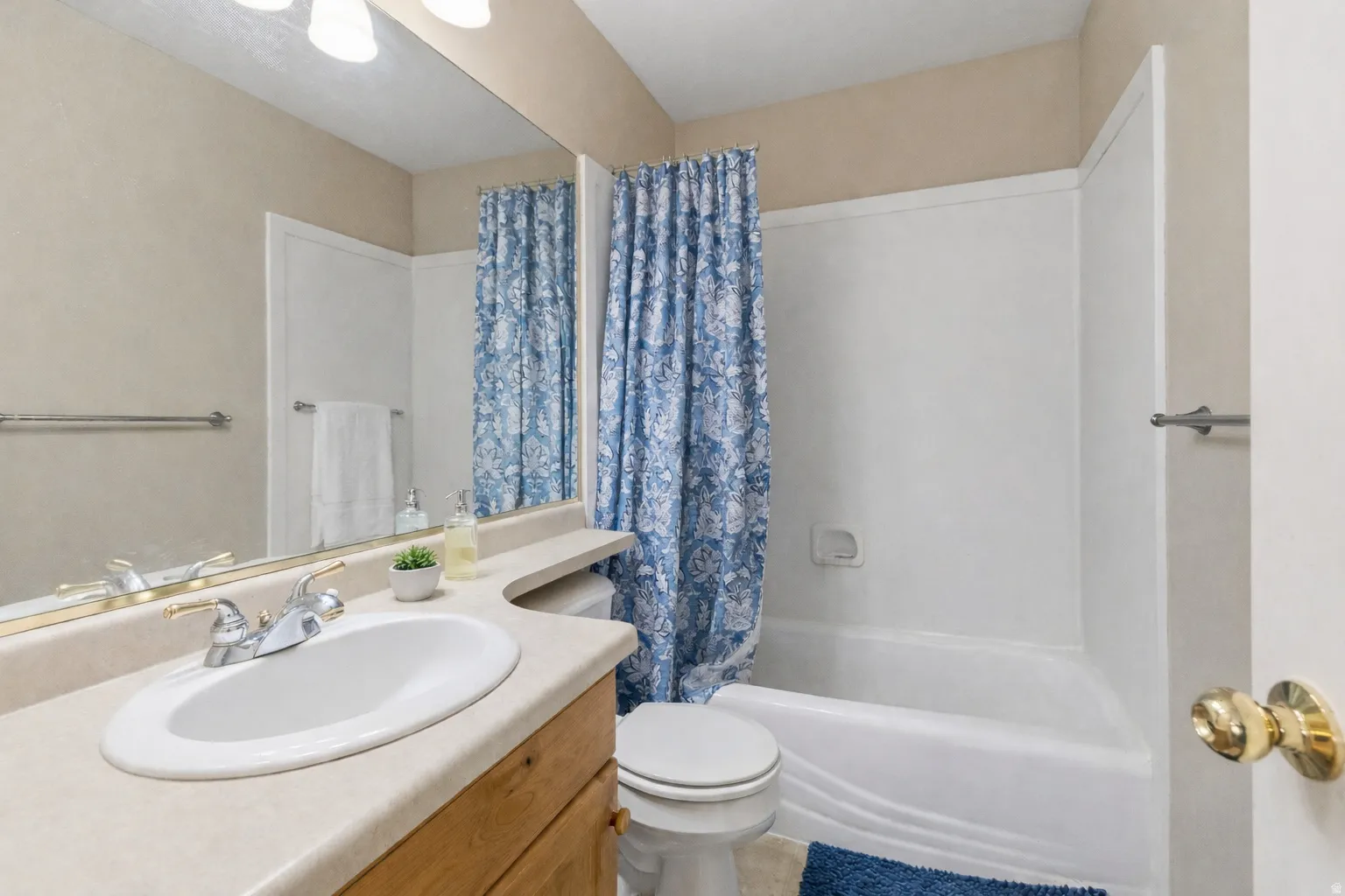 Vanity with an integrated sink, polished chrome faucet, and wood-finish cabinetry