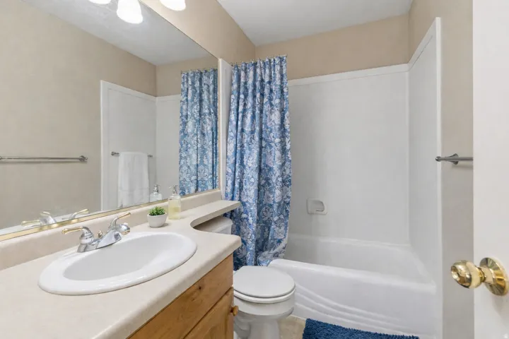 Vanity with an integrated sink, polished chrome faucet, and wood-finish cabinetry