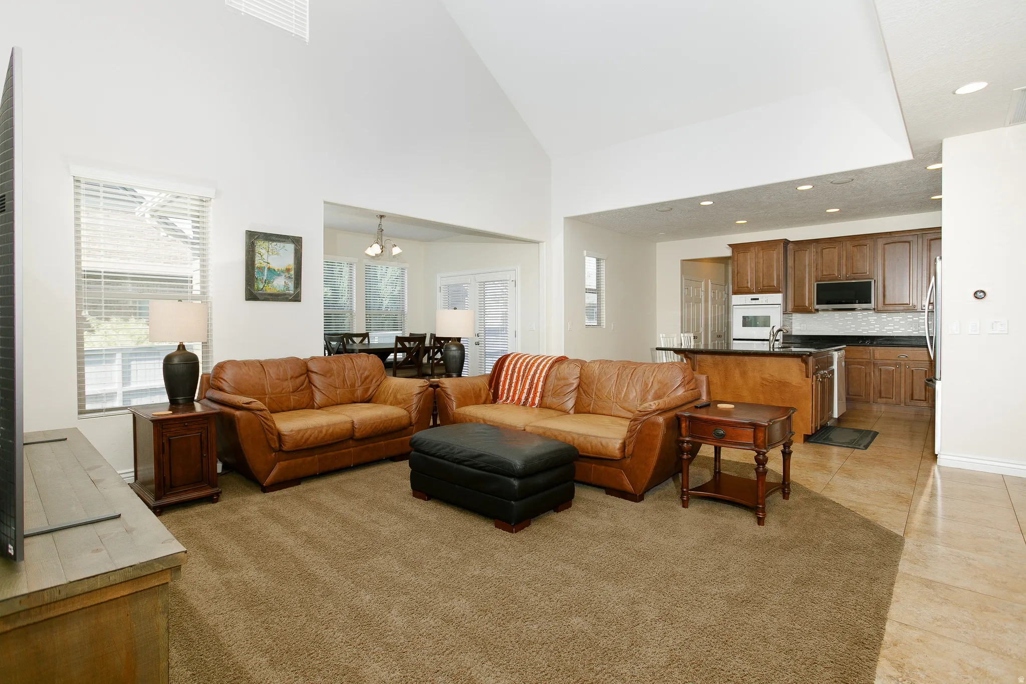 Vaulted ceiling, recessed lighting, and an open-concept layout