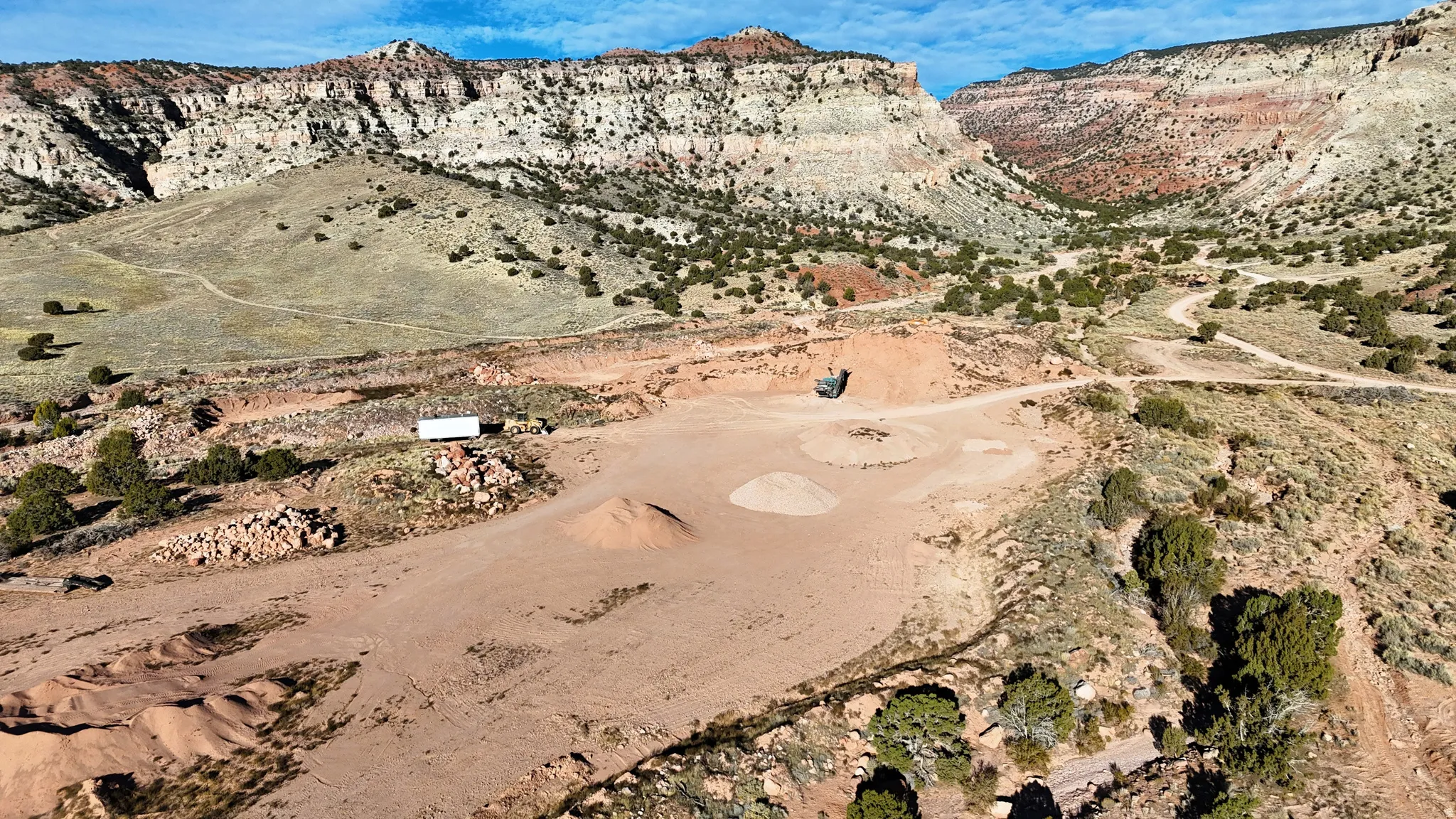 Expansive desert landscape with natural terrain and distant rock formations