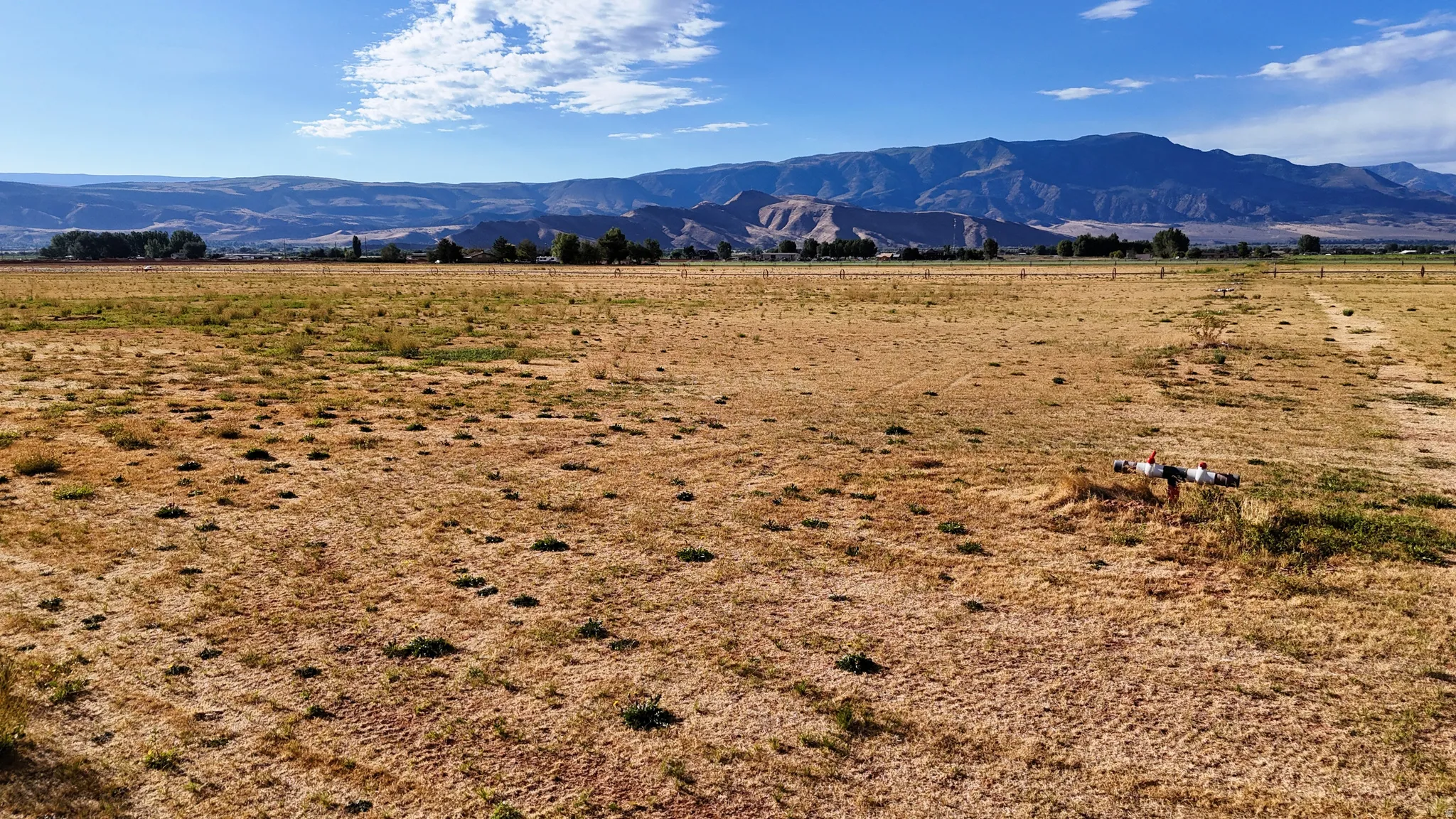 Expansive open land with a prominent mountain backdrop