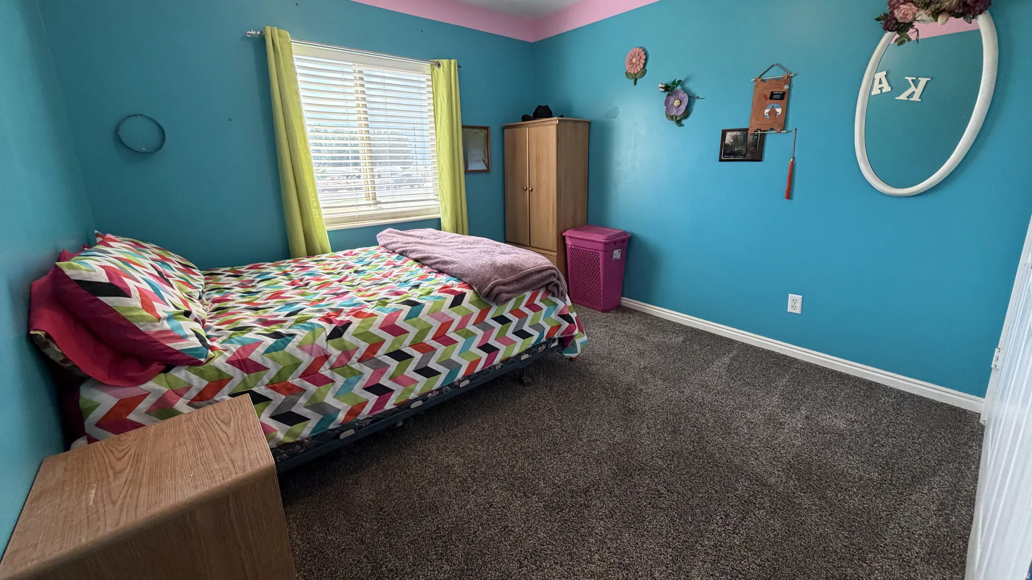 Carpeted flooring with painted walls, window with blinds, and white trim