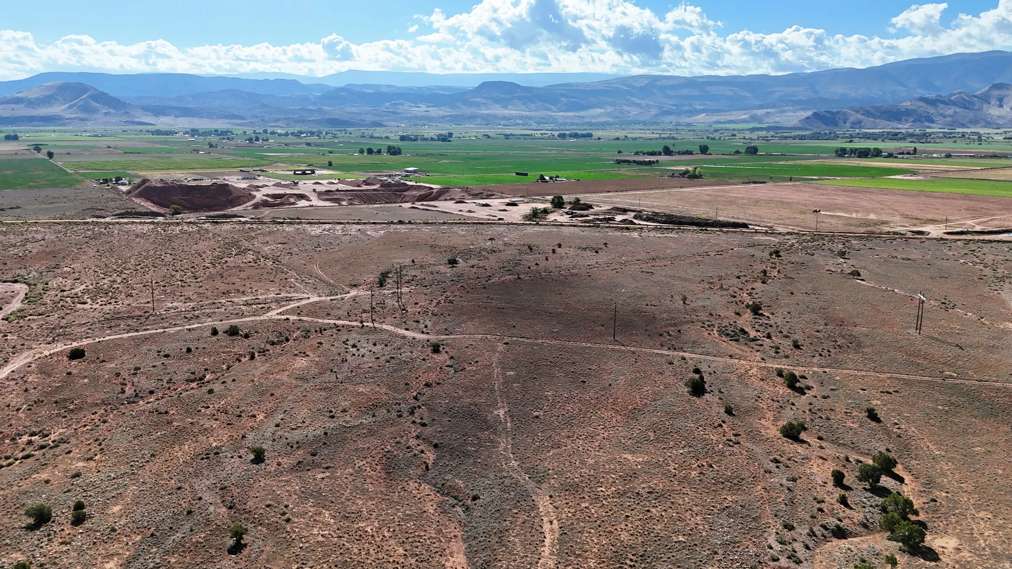 Expansive acreage featuring rugged terrain and distant mountain ranges