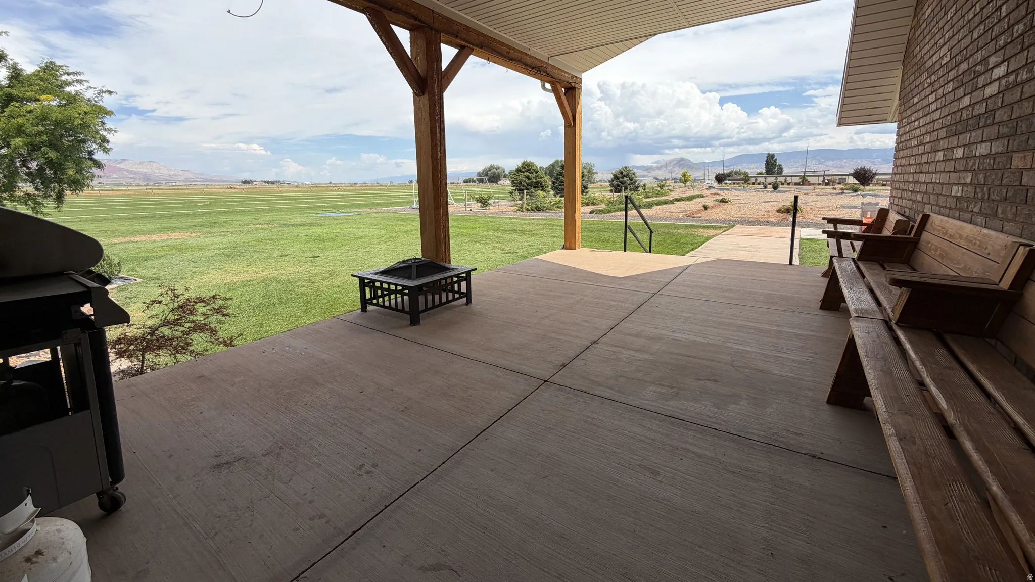 Covered patio featuring a concrete surface and brick exterior