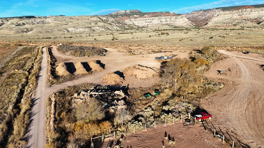 Expansive open terrain featuring a natural landscape and distant mountain formations