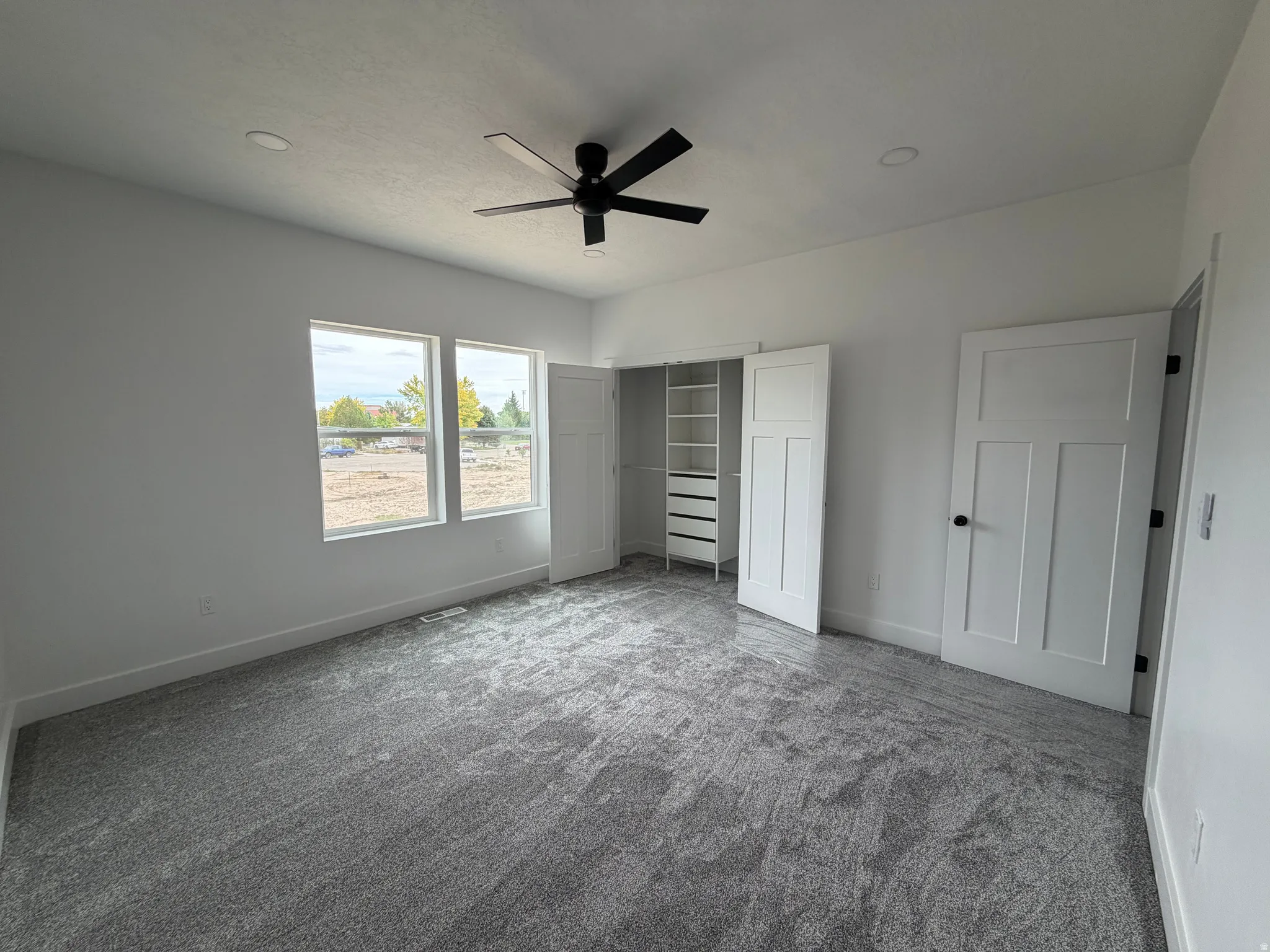 Bedroom 2 Spacious interior featuring neutral carpeting, recessed lighting, and a ceiling fan