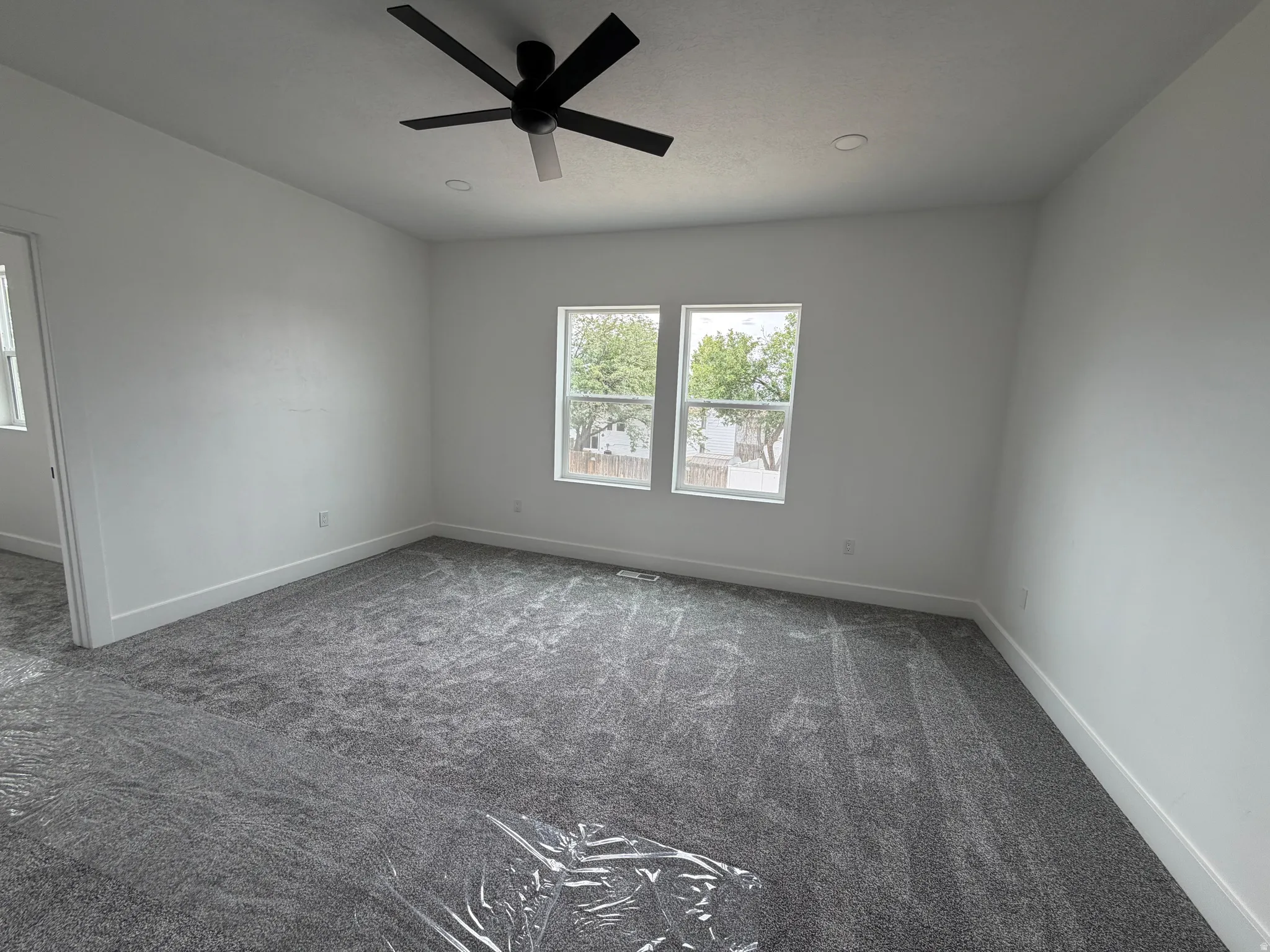 Master Bedroom - Recessed lighting, contemporary ceiling fan, dual windows, and plush grey carpeting