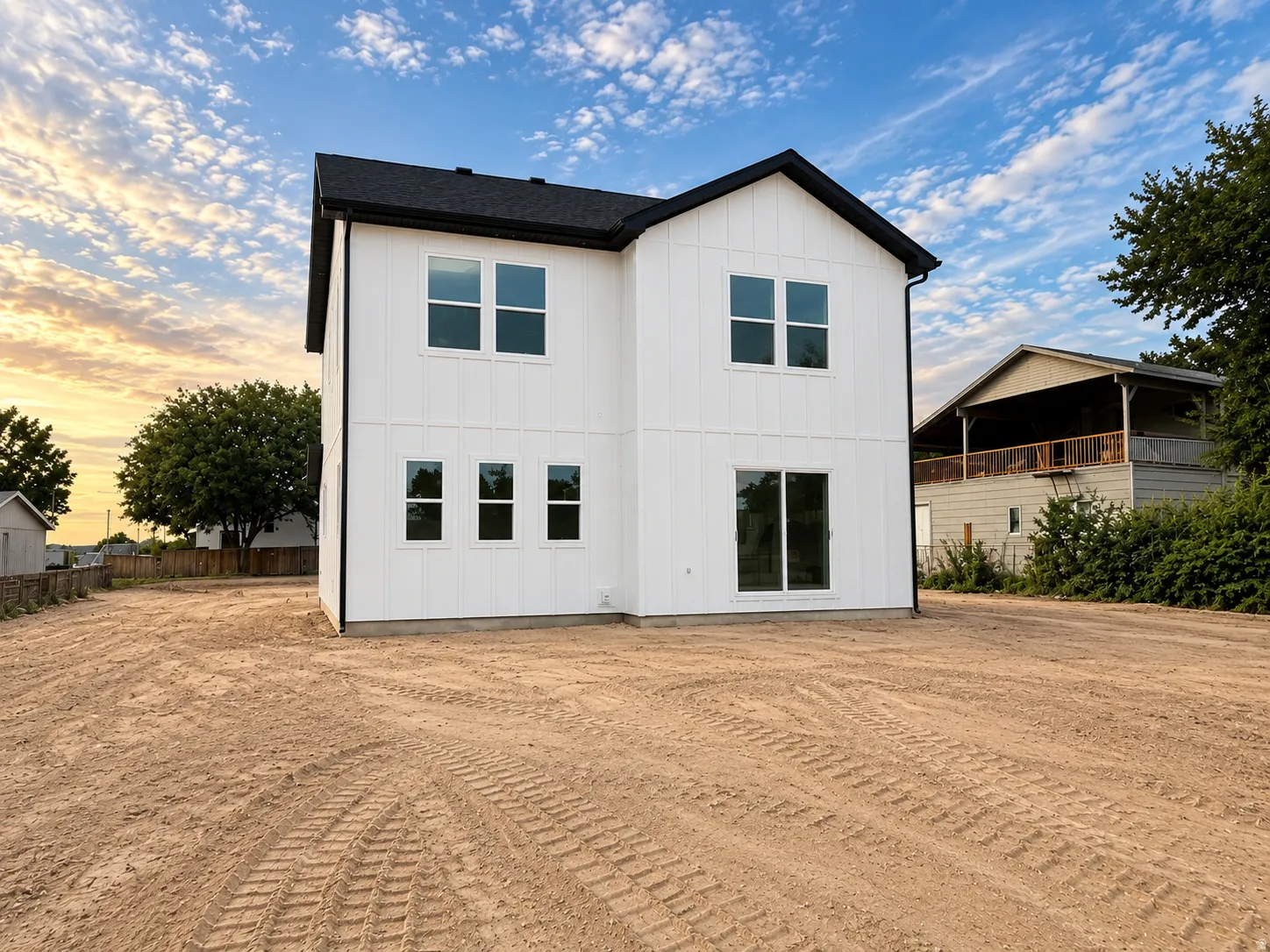 Two-story exterior with white vertical siding and black trim.