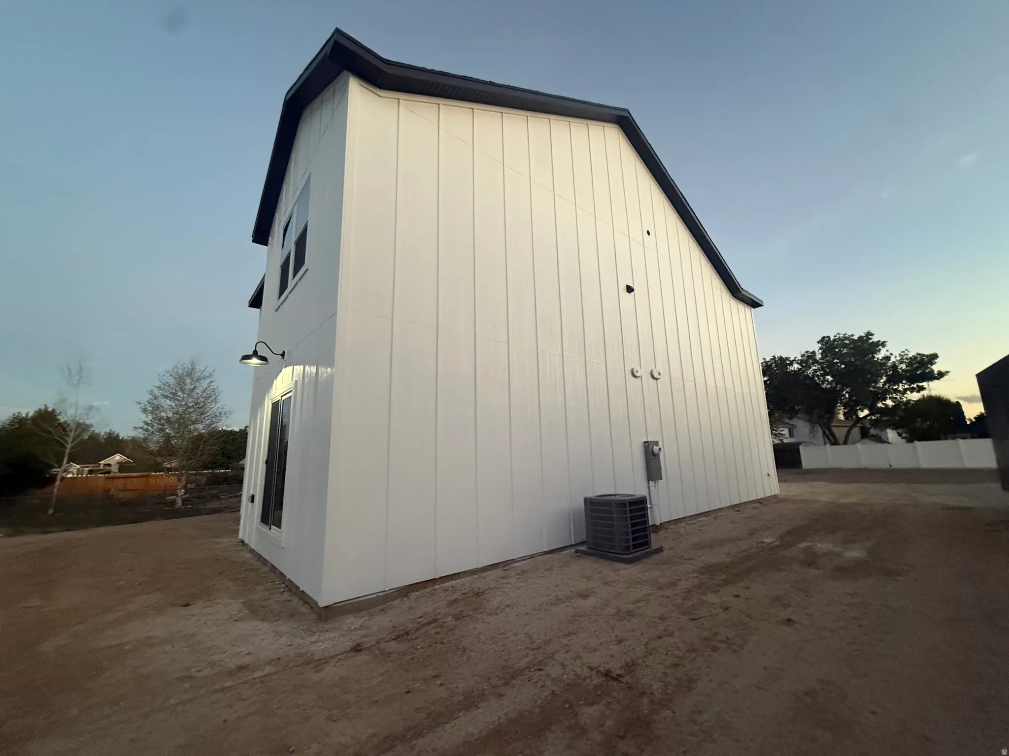 White board-and-batten siding exterior with dark trim