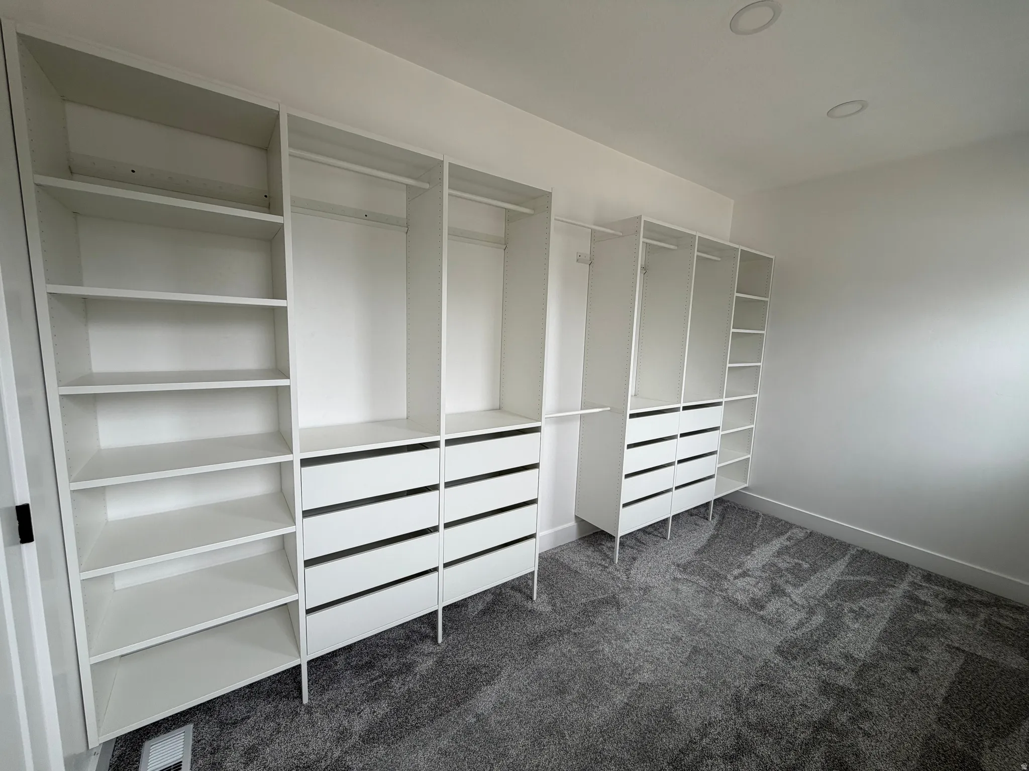 Master Closet - Custom closet system with multiple shelving units, hanging rods, and integrated drawers