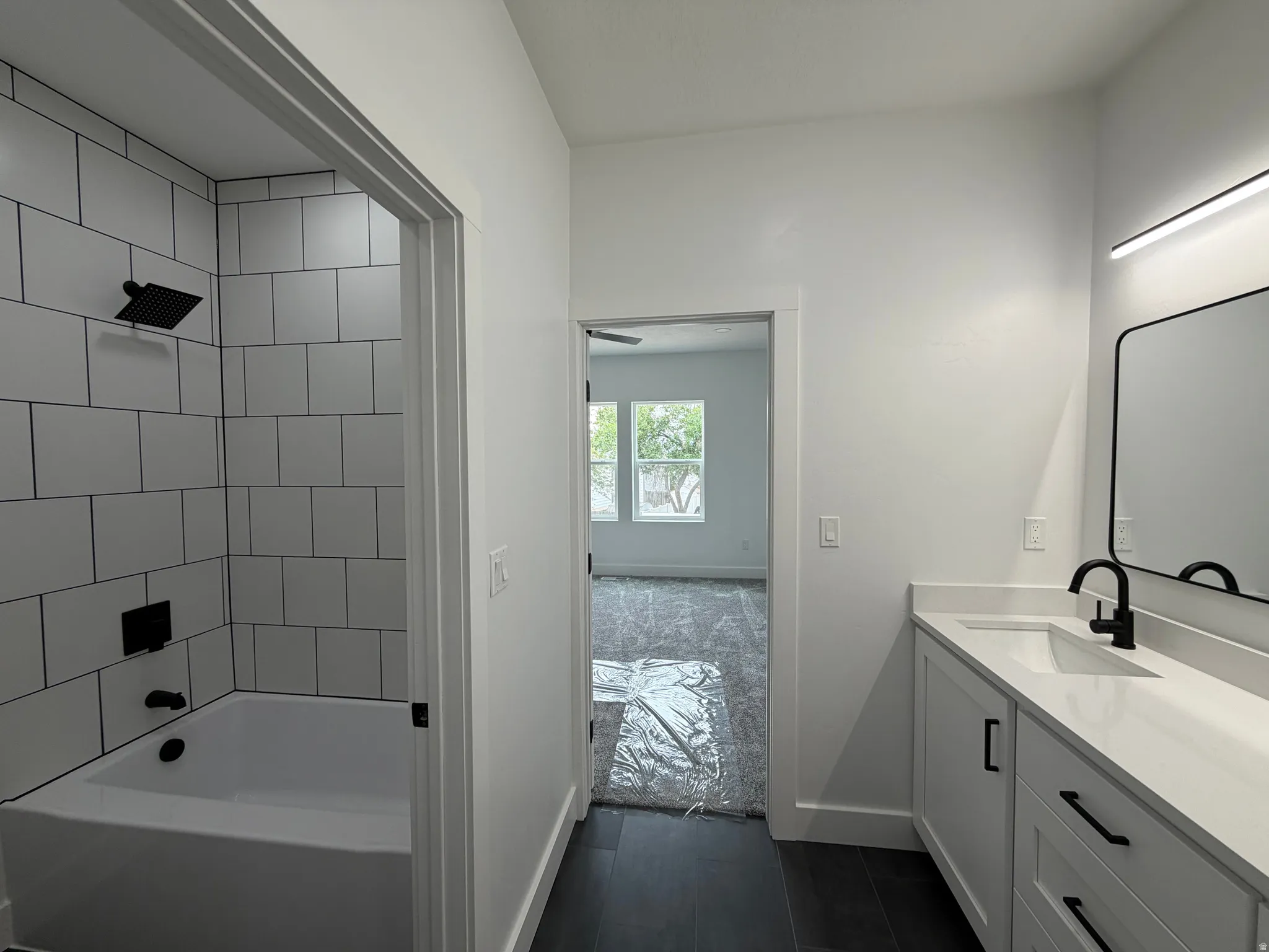 Master Bathroom - White subway tile shower surround with black fixtures
