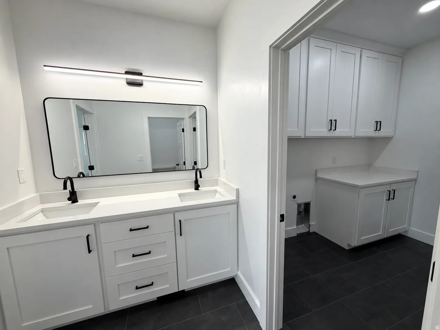 Master Bathroom - Dual vanity with white shaker cabinetry and integrated sinks