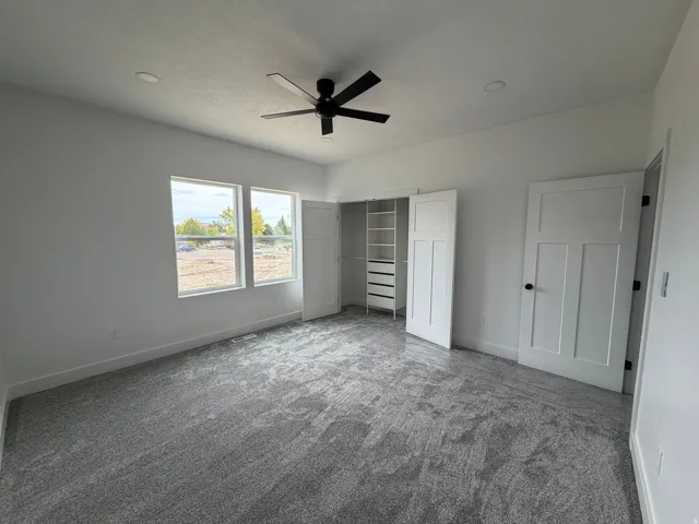 Bedroom 2 Spacious interior featuring neutral carpeting, recessed lighting, and a ceiling fan