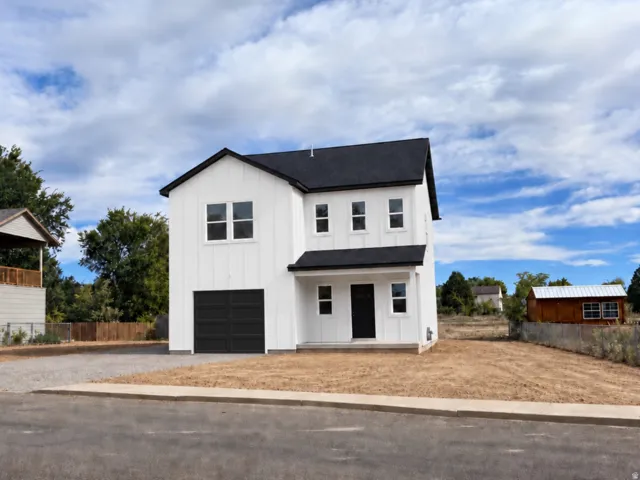 Two-story residence featuring white LP siding, a Black roof, an attached garage, and a covered entry. (This is an AI photo the house is currently being painted this week.)
