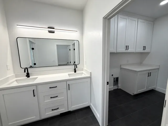 Master Bathroom - Dual vanity with white shaker cabinetry and integrated sinks