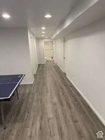 Recessed lighting, wood-finish flooring, white painted walls, and white trim throughout