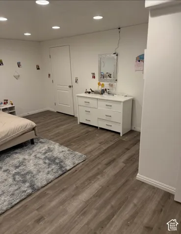 Recessed lighting, wood-finish flooring, white walls, and white baseboards