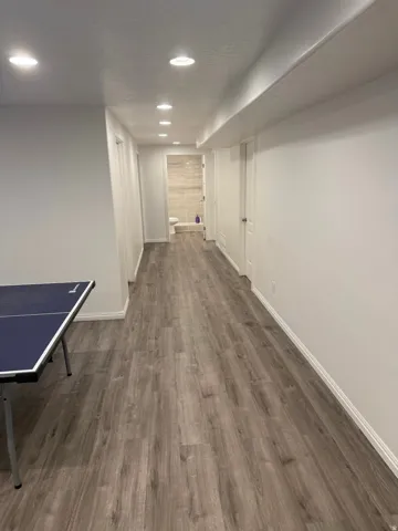 Recessed lighting, wood-finish flooring, white painted walls, and white trim throughout