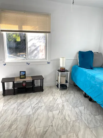White walls, chair rail molding, and large format tile flooring
