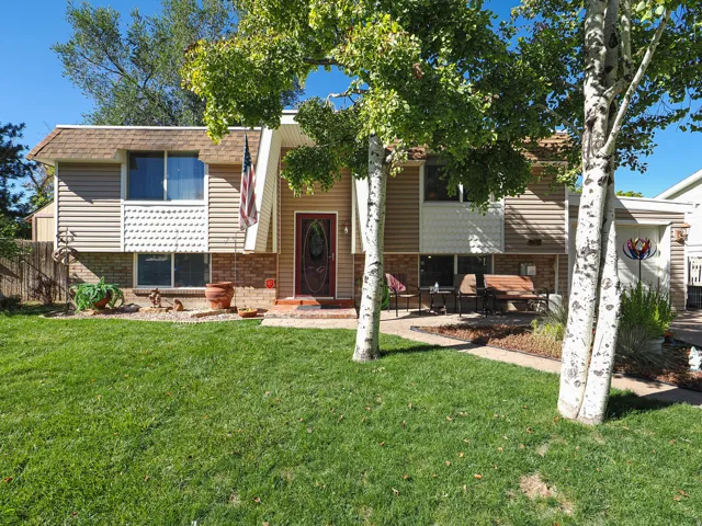 Split-level exterior with horizontal siding and brick accents