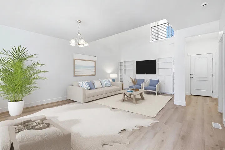 Spacious living area featuring high ceilings, light wood-finish flooring, built-in shelving, and an arched panel door