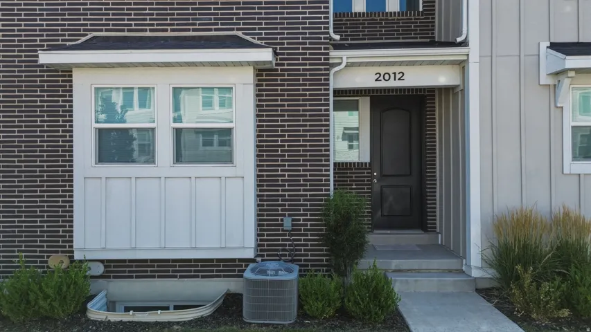 Exterior featuring a brick and siding facade, a prominent bay window with with a transom window