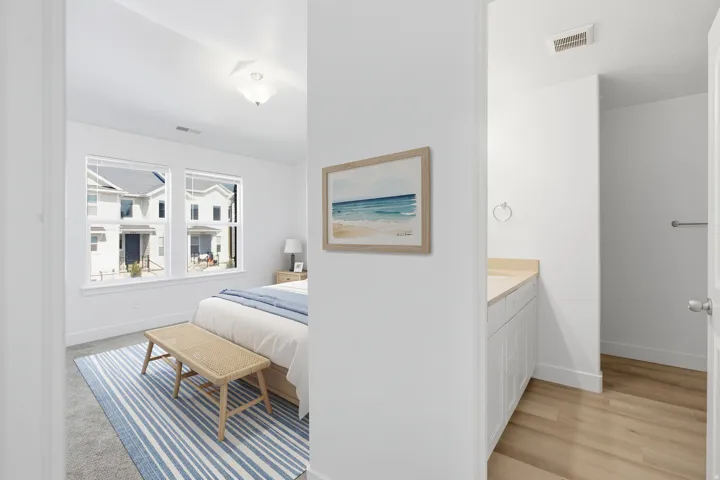 Two large windows provide natural light. Upstairs hallway view of bedroom / bathroom