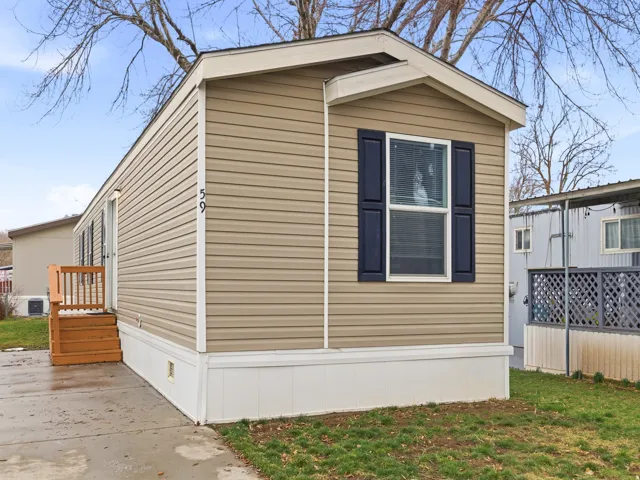 Beige horizontal siding exterior with a white trim