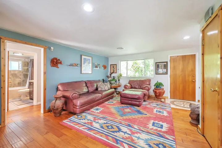 Recessed lighting, wood-finish flooring, and a window with natural light